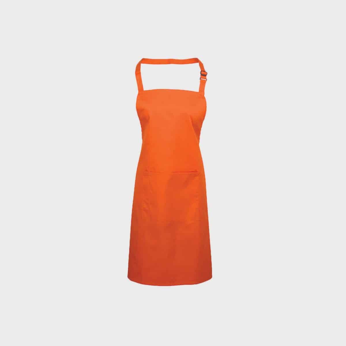 A bright orange PREMIER WORKWEAR bib apron with a pocket with neck strap and tied waistband can be seen against a plain white background. The apron has a single pocket at hip height.